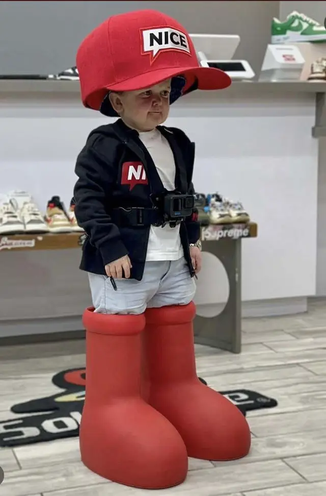 Hasbulla in a giant red cap and big red boots